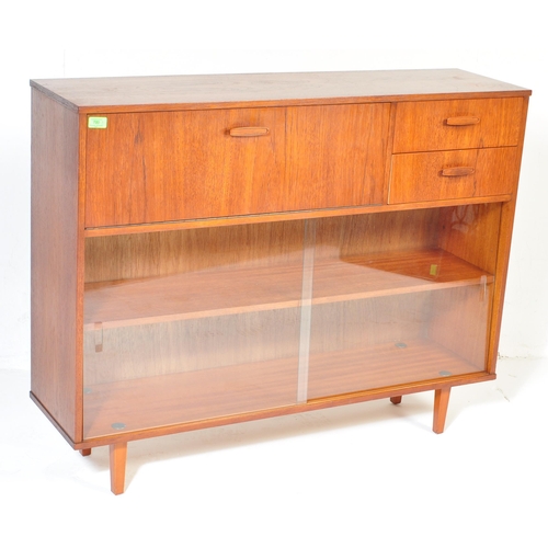 700 - Avalon - Mid 20th Century teak wall unit cabinet. Rectangular form with pull down door to left with ... 