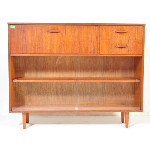 700 - Avalon - Mid 20th Century teak wall unit cabinet. Rectangular form with pull down door to left with ... 