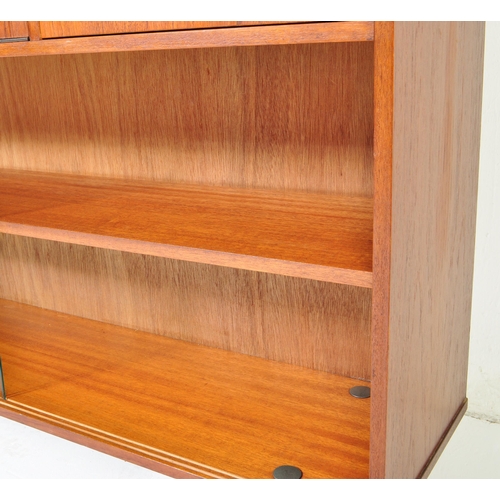 700 - Avalon - Mid 20th Century teak wall unit cabinet. Rectangular form with pull down door to left with ... 