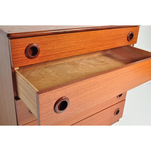 702 - A retro mid 20th century Danish inspired teak chest of drawers having a bank of five drawers each wi... 