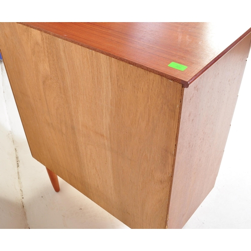 702 - A retro mid 20th century Danish inspired teak chest of drawers having a bank of five drawers each wi... 