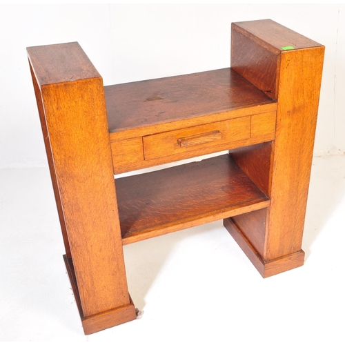 710 - An Art Deco early 20th century circa 1930s oak wood hall desk. The desk having a central top with si... 