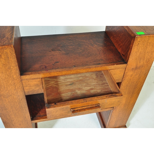 710 - An Art Deco early 20th century circa 1930s oak wood hall desk. The desk having a central top with si... 