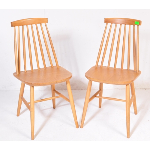 735 - Manner of Ercol Furniture – Pair of blond wood dining chairs. Raised on turned legs with stretchers,... 