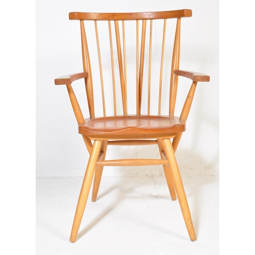 741 - A retro vintage mid 20th Century beech and elm G Plan Windsor chair. Having a spindle back with stra... 