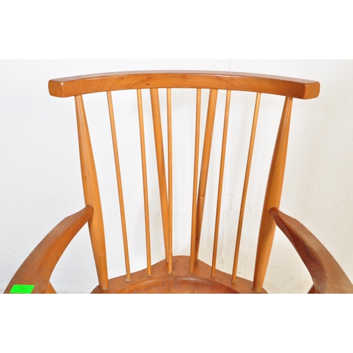 741 - A retro vintage mid 20th Century beech and elm G Plan Windsor chair. Having a spindle back with stra... 