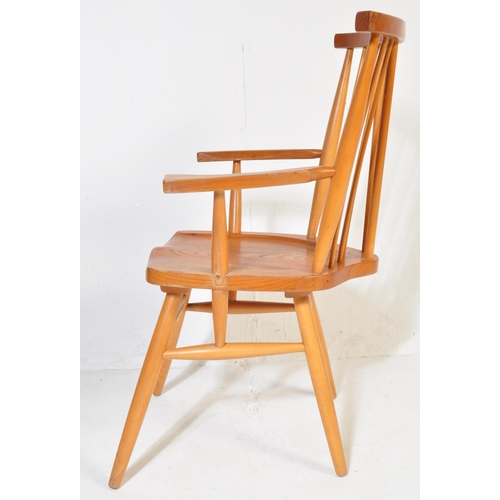 741 - A retro vintage mid 20th Century beech and elm G Plan Windsor chair. Having a spindle back with stra... 