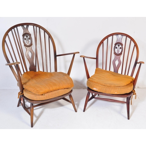 744 - A pair of retro vintage mid 20th Century beech & elm fleur de lis low arm chairs. Both having round ... 