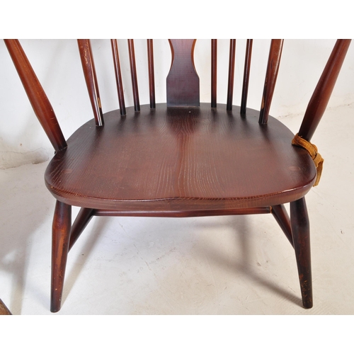 744 - A pair of retro vintage mid 20th Century beech & elm fleur de lis low arm chairs. Both having round ... 
