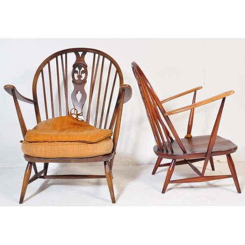 744 - A pair of retro vintage mid 20th Century beech & elm fleur de lis low arm chairs. Both having round ... 
