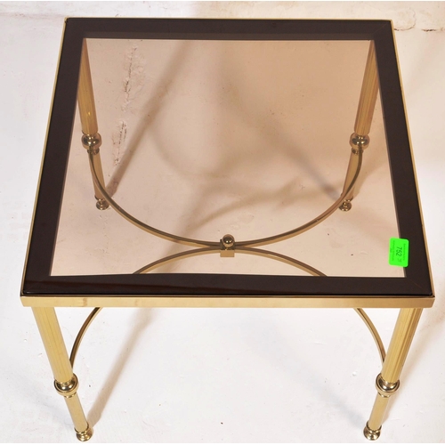752 - A 20th Century 1980s Hollywood Regency brass framed coffee table / low table of square form having a... 