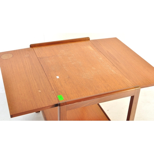 765 - A mid 20th Century retro vintage teak wood serving trolley. With twin drop leaves rectangular form w... 