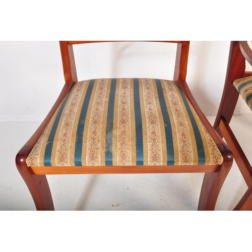 802 - A vintage 20th Century yew wood dining table with chairs. The table of oval form with veneer top ree... 