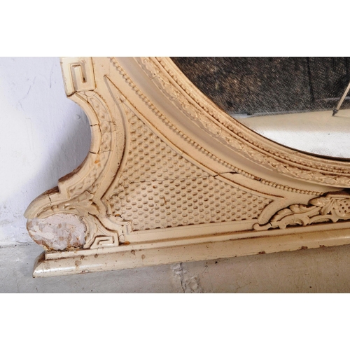 813 - A 19th Century Victorian over mantel wall mirror of oval form having a large glass mirror panel set ... 