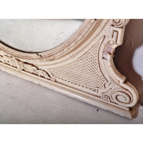 813 - A 19th Century Victorian over mantel wall mirror of oval form having a large glass mirror panel set ... 