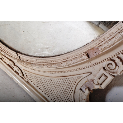 813 - A 19th Century Victorian over mantel wall mirror of oval form having a large glass mirror panel set ... 