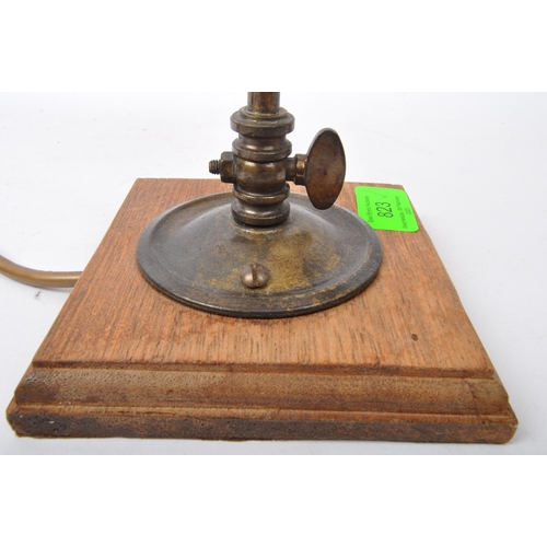 823 - An early 20th Century French Art Nouveau glass table lamp light. Having a brass metal arm with paint... 