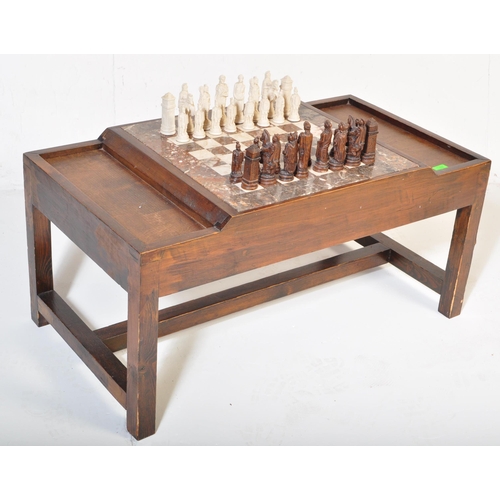 852 - A vintage wood custom chess board table. The game table having a fitted stone chess board with mould... 