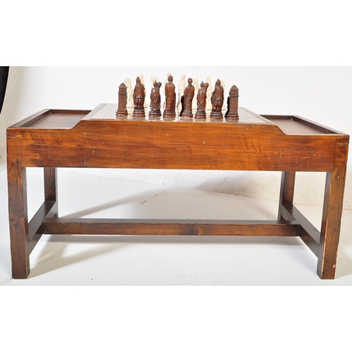 852 - A vintage wood custom chess board table. The game table having a fitted stone chess board with mould... 
