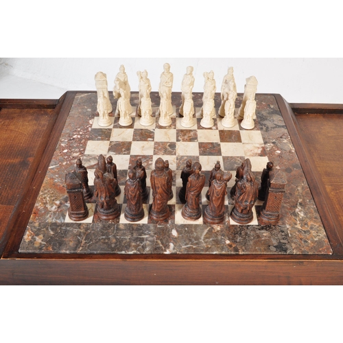 852 - A vintage wood custom chess board table. The game table having a fitted stone chess board with mould... 