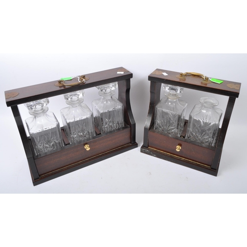 858 - A pair of early 20th century Decanter tantalus's. Each having cut glass decanters in mahogany brass ... 