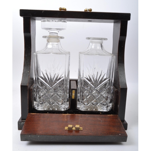 858 - A pair of early 20th century Decanter tantalus's. Each having cut glass decanters in mahogany brass ... 