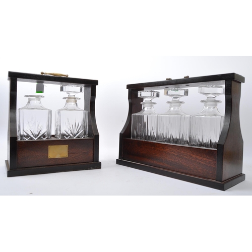 858 - A pair of early 20th century Decanter tantalus's. Each having cut glass decanters in mahogany brass ... 