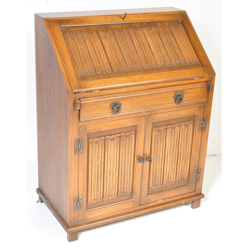 930 - A Jacobean revival 20th century Old Charm / Jaycee manner oak bureau desk. With linen fold design to... 