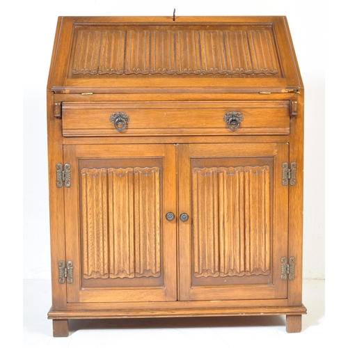 930 - A Jacobean revival 20th century Old Charm / Jaycee manner oak bureau desk. With linen fold design to... 