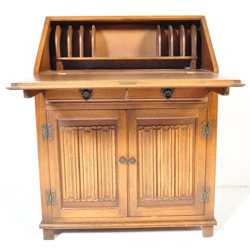 930 - A Jacobean revival 20th century Old Charm / Jaycee manner oak bureau desk. With linen fold design to... 