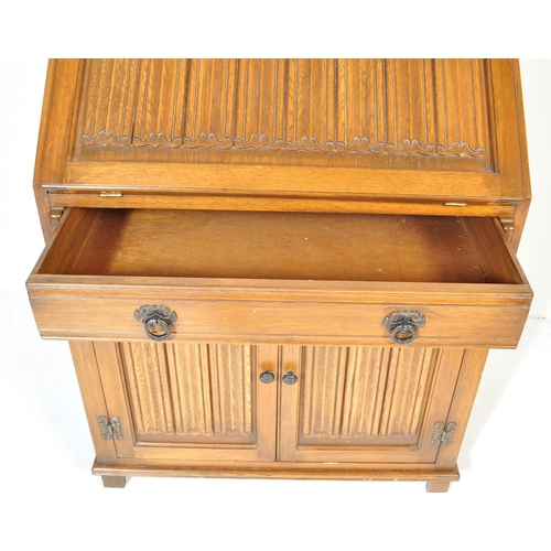 930 - A Jacobean revival 20th century Old Charm / Jaycee manner oak bureau desk. With linen fold design to... 