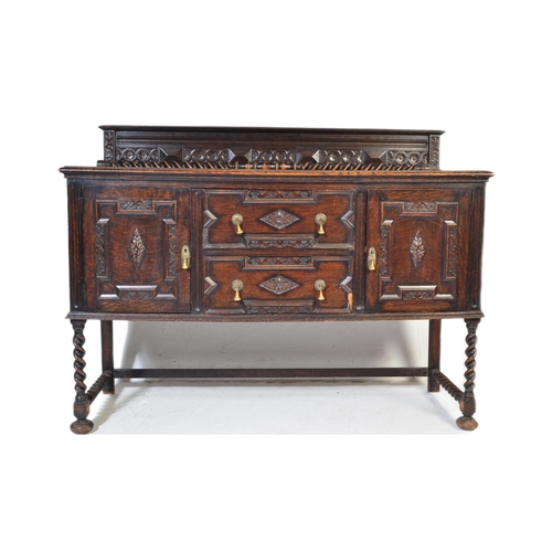 937 - An early 20th century Jacobean Revival oak sideboard. The credenza having a decorated gallery back o... 