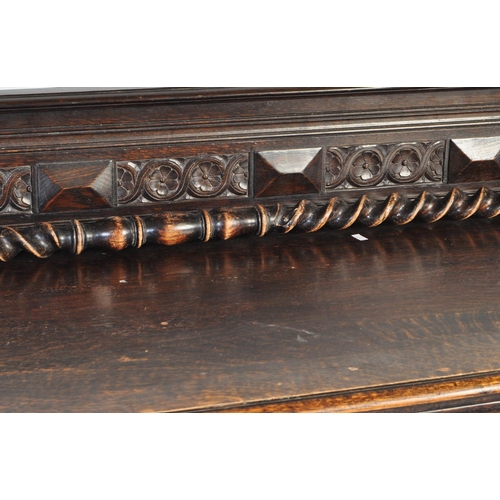 937 - An early 20th century Jacobean Revival oak sideboard. The credenza having a decorated gallery back o... 