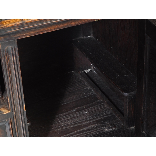 937 - An early 20th century Jacobean Revival oak sideboard. The credenza having a decorated gallery back o... 