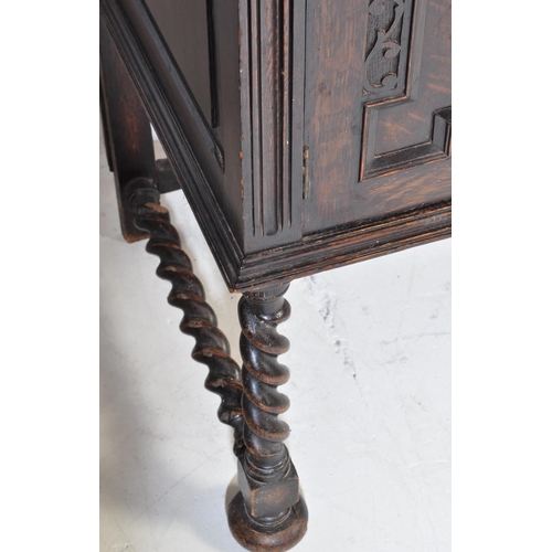 937 - An early 20th century Jacobean Revival oak sideboard. The credenza having a decorated gallery back o... 