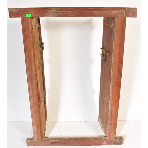 945 - An early 20th Century Indian hand carved solid teak wood door. Small form with two doors with carved... 