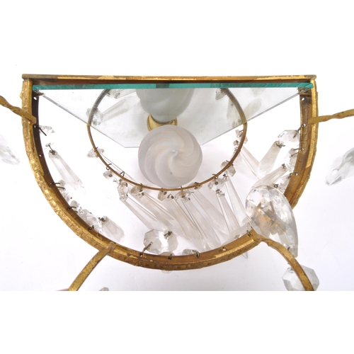 961 - A pair of early 20th Century gilt metal wall lights. Having loose mirror back with decorated gilt me... 