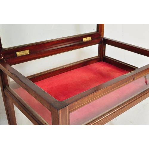 987 - An Edwardian early 20th Century circa 1900s bijouterie cabinet table. Of rectangular form with glass... 