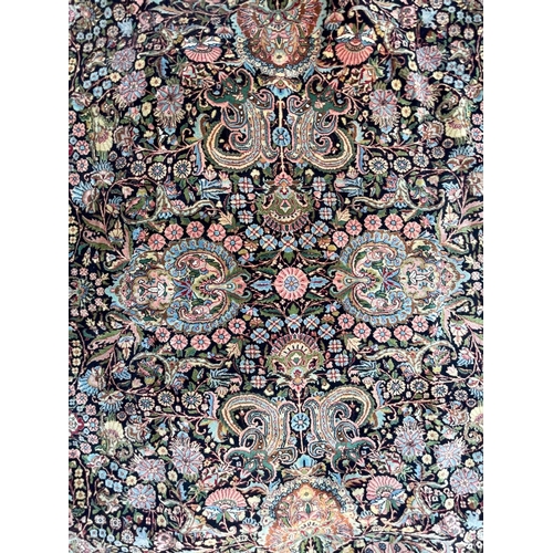 924 - A vintage 20th Century hand knotted Kirman Persian Islamic floor carpet rug. Having an intricate pol... 