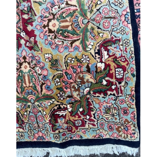 924 - A vintage 20th Century hand knotted Kirman Persian Islamic floor carpet rug. Having an intricate pol... 