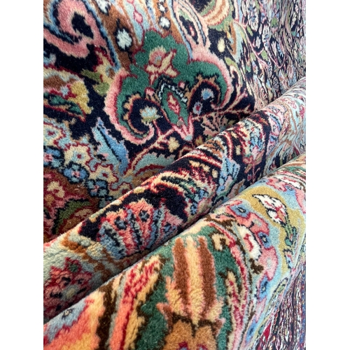 924 - A vintage 20th Century hand knotted Kirman Persian Islamic floor carpet rug. Having an intricate pol... 