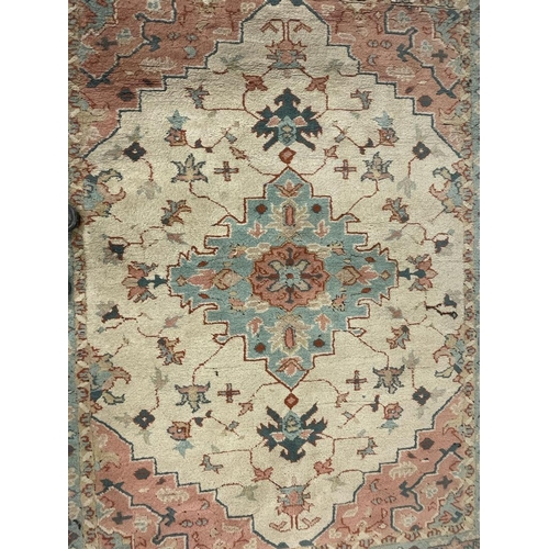 926 - A large mid 20th Century Turkish woven floor rug / carpet having repeating geometric and floral patt... 
