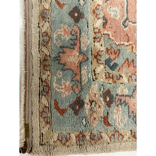 926 - A large mid 20th Century Turkish woven floor rug / carpet having repeating geometric and floral patt... 