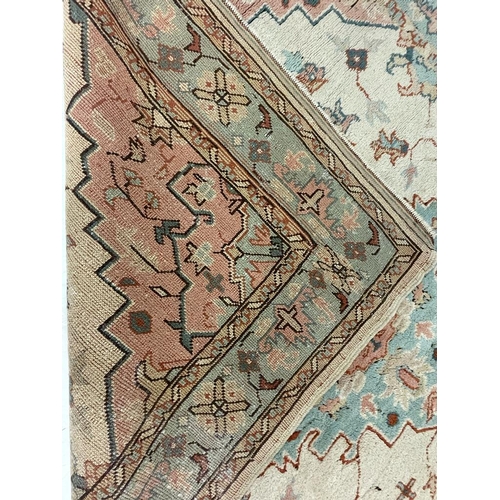 926 - A large mid 20th Century Turkish woven floor rug / carpet having repeating geometric and floral patt... 