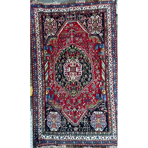 931 - An early 20th Century Gashai Persian Islamic carpet floor rug. Having virgin pile wool with red and ... 