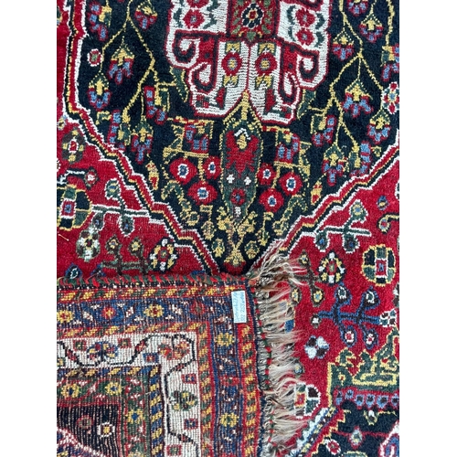 931 - An early 20th Century Gashai Persian Islamic carpet floor rug. Having virgin pile wool with red and ... 
