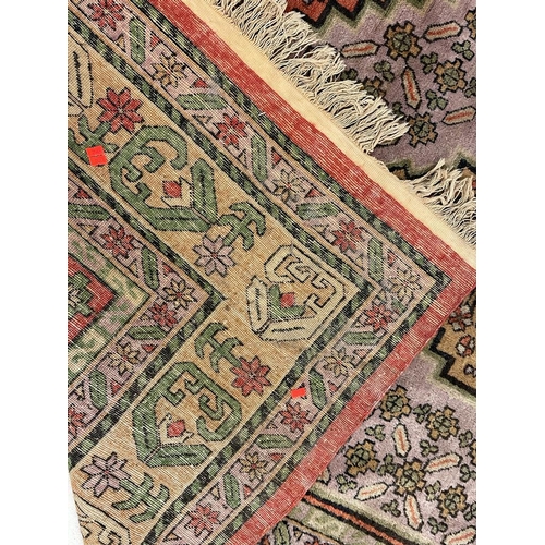 933 - A large mid 20th Century Turkish woven floor rug / carpet having repeating geometric and floral patt... 