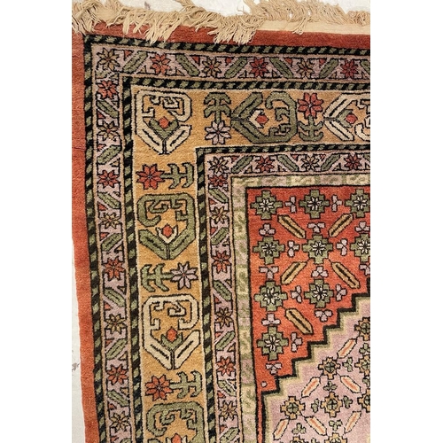 933 - A large mid 20th Century Turkish woven floor rug / carpet having repeating geometric and floral patt... 