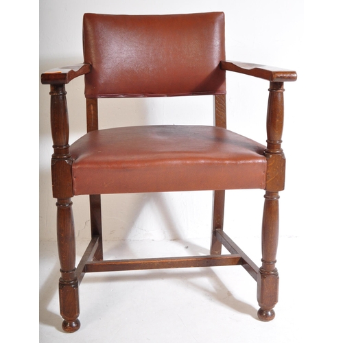 1043 - A mid 20th century circa. 1940's carver desk chair. The chair having oak arm rests over seat and bac... 