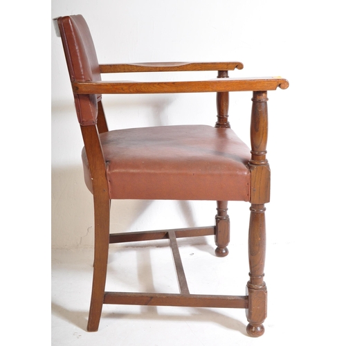 1043 - A mid 20th century circa. 1940's carver desk chair. The chair having oak arm rests over seat and bac... 